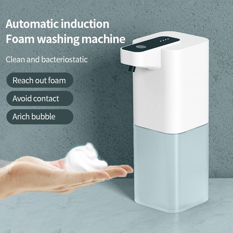 Automatic induction foam washing machine dispensing foam into a hand against a gray background
