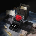 Gray gift box with a red rose and jewelry on a decorative surface