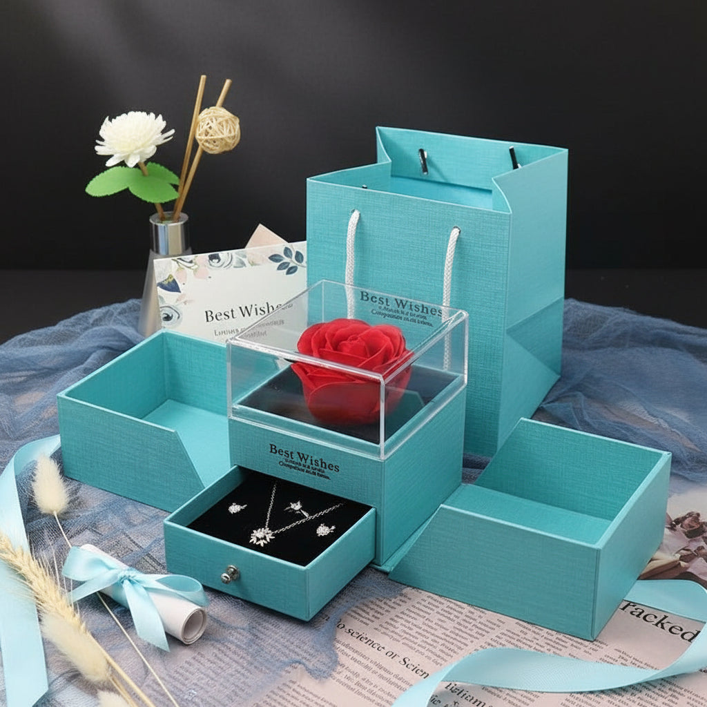 Turquoise jewelry box with a red rose and necklace on a newspaper background