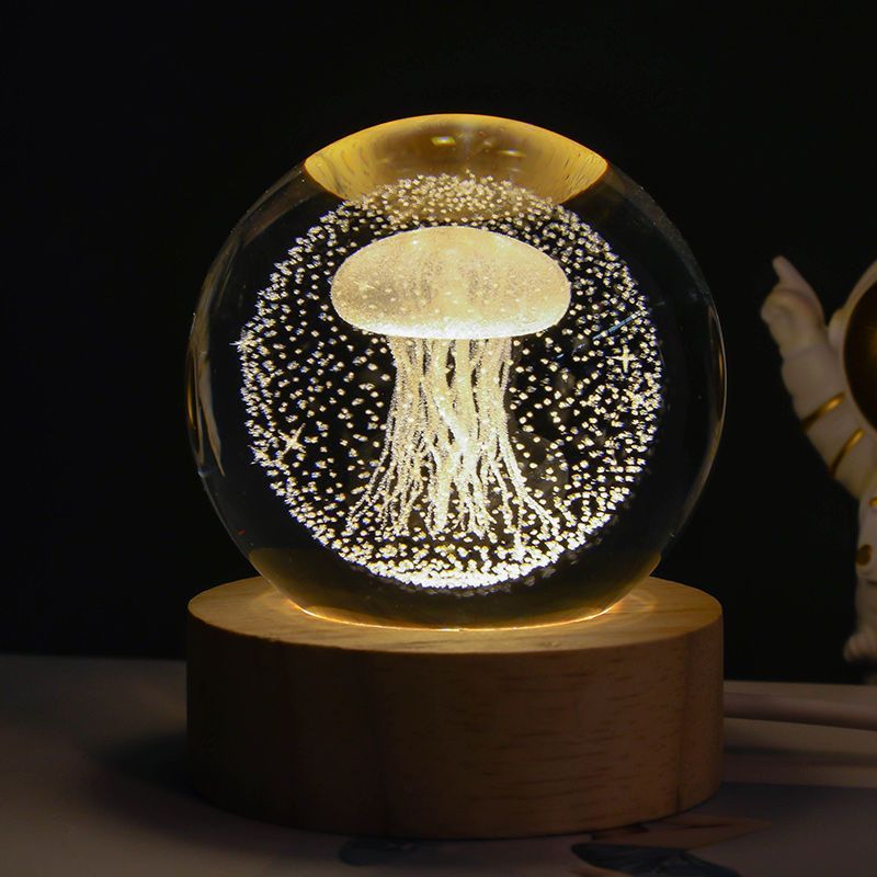 Glowing jellyfish inside a transparent sphere on a wooden base with a dark background