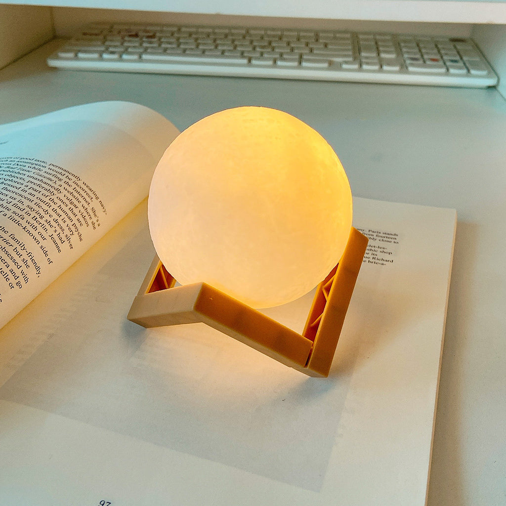 Round lamp with wooden base on an open book