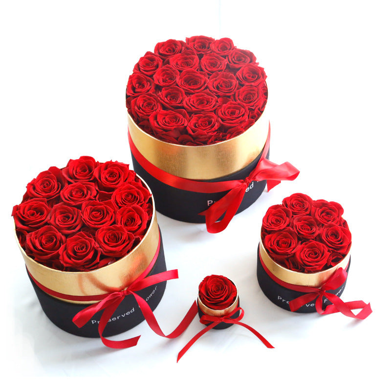 Set of red rose bouquets in round boxes with ribbons on a white background