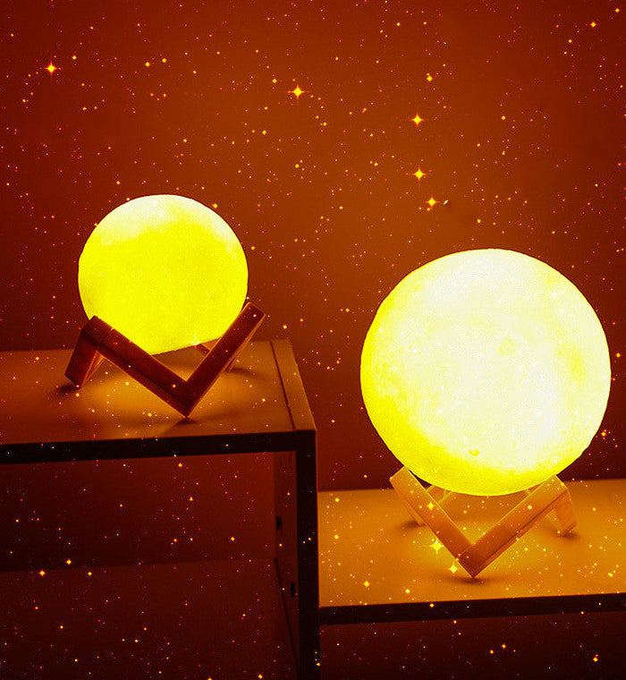 Two moon-shaped lamps on stands with a starry night background