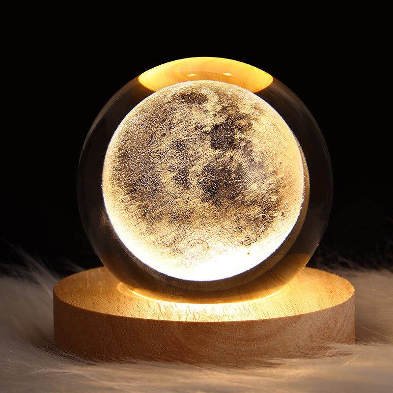 Moon lamp with wooden base on a dark background